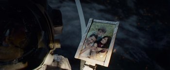 Movie still from “Gravity” (2013), directed by Alfonso Cuarón – A picture of a man and a woman and a child; Extreme Close Up shot, Over the shoulder angle