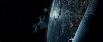 Movie still from “Gravity” (2013), directed by Alfonso Cuarón – An image of an astronaut in the space above the earth; Extreme Wide shot, Overhead angle
