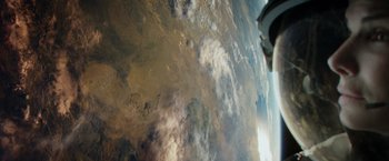 Movie still from “Gravity” (2013), directed by Alfonso Cuarón – A view of the earth taken from a space station; Extreme Wide shot, Overhead angle