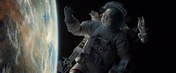 Movie still from “Gravity” (2013), directed by Alfonso Cuarón – An image of an astronaut in the space; Wide shot, Overhead angle