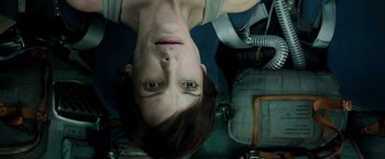 Movie still from “Gravity” (2013), directed by Alfonso Cuarón – A woman is hanging upside down in a room; Close Up shot, Overhead angle