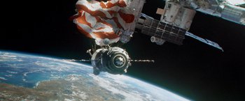 Movie still from “Gravity” (2013), directed by Alfonso Cuarón – An image of an american flag on the side of a space station; Extreme Wide shot, Low angle