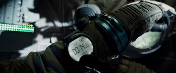 Movie still from “Gravity” (2013), directed by Alfonso Cuarón – A stopwatch sitting on top of a camera; Extreme Close Up shot, Overhead angle