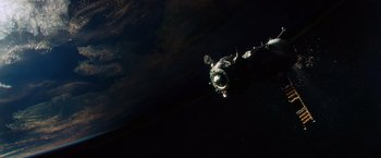 Movie still from “Gravity” (2013), directed by Alfonso Cuarón – An image of an astronaut floating in the space; Extreme Wide shot, Overhead angle