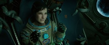 Movie still from “Gravity” (2013), directed by Alfonso Cuarón – A woman in a space suit is posing for a picture; Close Up shot, Overhead angle