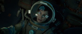 Movie still from “Gravity” (2013), directed by Alfonso Cuarón – A woman in a spacesuit looking into a mirror; Medium shot, Overhead angle