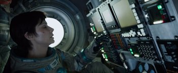 Movie still from “Gravity” (2013), directed by Alfonso Cuarón – A person in a spacesuit is inside a space station; Medium shot, Overhead angle