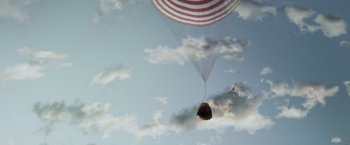Movie still from “Gravity” (2013), directed by Alfonso Cuarón – An american flag balloon flying through the sky; Extreme Wide shot, Low angle