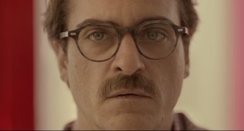 Movie still from “Her” (2013), directed by Spike Jonze – A person wearing glasses and a mustache; Close Up shot, Low angle
