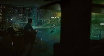 Movie still from “Her” (2013), directed by Spike Jonze – A man sitting on a chair in front of a large window; Extreme Wide shot, High angle