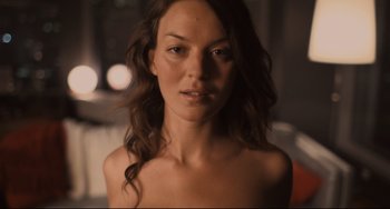 Movie still from “Her” (2013), directed by Spike Jonze – A beautiful woman with long brown curly hair; Close Up shot, Overhead angle