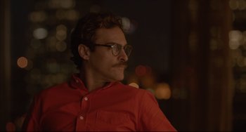Movie still from “Her” (2013), directed by Spike Jonze – A man wearing glasses and a red shirt; Close Up shot, Over the shoulder angle
