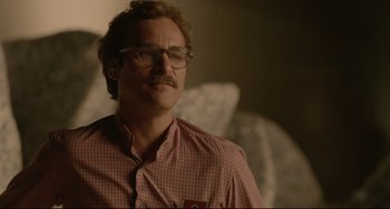 Movie still from “Her” (2013), directed by Spike Jonze – A man with glasses and a beard is looking at the camera; Close Up shot, Over the shoulder angle