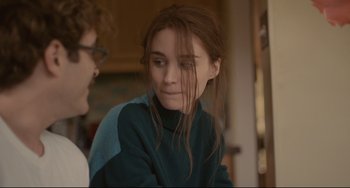 Movie still from “Her” (2013), directed by Spike Jonze – A young girl with long brown hair sitting next to a man; Close Up shot, Over the shoulder angle