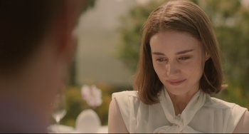 Movie still from “Her” (2013), directed by Spike Jonze – A woman in a white shirt is looking down; Close Up shot, Over the shoulder angle