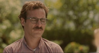 Movie still from “Her” (2013), directed by Spike Jonze – A person wearing glasses and a plaid shirt; Close Up shot, Over the shoulder angle