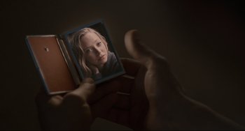 Movie still from “Her” (2013), directed by Spike Jonze – A person holding a picture of a young girl; Extreme Close Up shot, Over the shoulder angle
