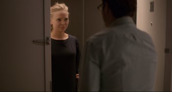 Movie still from “Her” (2013), directed by Spike Jonze – A woman standing in front of a mirror looking at a man; Medium shot, Over the shoulder angle