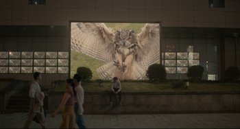 Movie still from “Her” (2013), directed by Spike Jonze – A man sitting in front of an owl on a screen; Extreme Wide shot, Low angle