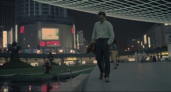 Movie still from “Her” (2013), directed by Spike Jonze – A man walking down a sidewalk at night; Wide shot, High angle