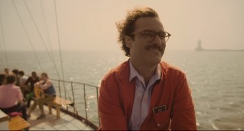 Movie still from “Her” (2013), directed by Spike Jonze – A man in a red jacket sitting on a boat in front of the ocean; Close Up shot, Over the shoulder angle