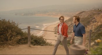 Movie still from “Her” (2013), directed by Spike Jonze – Two men are walking on a hill near the ocean; Wide shot, Over the shoulder angle
