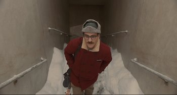 Movie still from “Her” (2013), directed by Spike Jonze – A man standing in the middle of a snow tunnel; Medium shot, Overhead angle