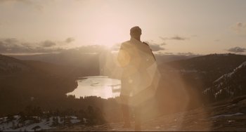 Movie still from “Her” (2013), directed by Spike Jonze – A man standing on top of a mountain looking at the sunset; Extreme Wide shot, Low angle