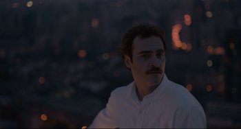 Movie still from “Her” (2013), directed by Spike Jonze – A man in a white dress shirt is looking at the camera; Close Up shot, Low angle
