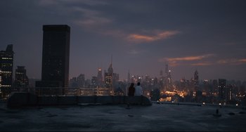 Movie still from “Her” (2013), directed by Spike Jonze – Two people sitting on a ledge overlooking a city; Extreme Wide shot, High angle