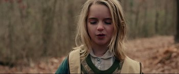 Movie still from “I, Tonya” (2017), directed by Craig Gillespie – A young girl with long blonde hair is looking down at the ground; Close Up shot, Over the shoulder angle