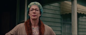 Movie still from “I, Tonya” (2017), directed by Craig Gillespie – An older woman wearing glasses and a hat; Close Up shot, Low angle
