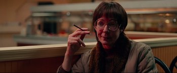 Movie still from “I, Tonya” (2017), directed by Craig Gillespie – A woman sitting in front of a window smoking a cigarette; Close Up shot, Low angle