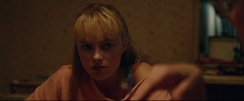 Movie still from “I, Tonya” (2017), directed by Craig Gillespie – A young woman is looking at the camera; Close Up shot, Low angle