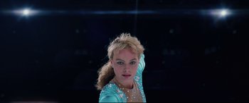Movie still from “I, Tonya” (2017), directed by Craig Gillespie – A woman in a blue dress posing for a picture; Close Up shot, Low angle