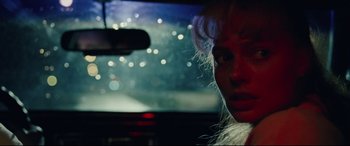 Movie still from “I, Tonya” (2017), directed by Craig Gillespie – A woman in a car looking out of the window; Close Up shot, Over the shoulder angle
