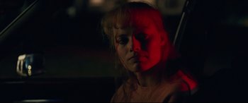 Movie still from “I, Tonya” (2017), directed by Craig Gillespie – A woman with a red light on her face; Close Up shot, Over the shoulder angle