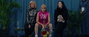 Movie still from “I, Tonya” (2017), directed by Craig Gillespie – A group of women sitting next to each other on a bench; Medium shot, High angle