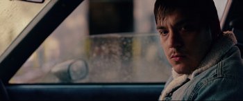 Movie still from “I, Tonya” (2017), directed by Craig Gillespie – A person sitting in a car looking at the camera; Close Up shot, Over the shoulder angle