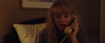 Movie still from “I, Tonya” (2017), directed by Craig Gillespie – A woman is talking on a phone while sitting on a bed; Close Up shot, High angle