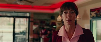 Movie still from “I, Tonya” (2017), directed by Craig Gillespie – An older woman wearing glasses standing in a restaurant; Close Up shot, Low angle