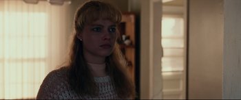 Movie still from “I, Tonya” (2017), directed by Craig Gillespie – A woman with long blonde hair wearing a white sweater; Close Up shot, Over the shoulder angle