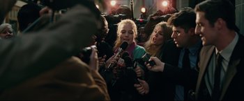 Movie still from “I, Tonya” (2017), directed by Craig Gillespie – A group of people standing next to each other holding microphones; Medium shot, Over the shoulder angle