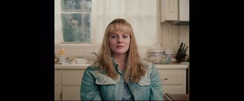 Movie still from “I, Tonya” (2017), directed by Craig Gillespie – A woman with long blonde hair wearing a jean jacket; Close Up shot, High angle