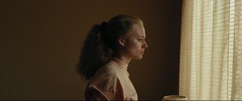 Movie still from “I, Tonya” (2017), directed by Craig Gillespie – A woman with a ponytail is looking to her left; Close Up shot, Low angle