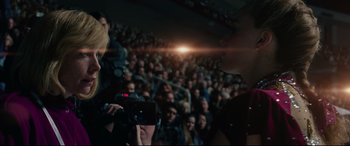 Movie still from “I, Tonya” (2017), directed by Craig Gillespie – A person taking a picture of a crowd of people in an auditorium; Medium shot, Low angle