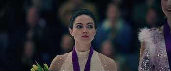 Movie still from “I, Tonya” (2017), directed by Craig Gillespie – A person with a medal around her neck; Close Up shot, Over the shoulder angle