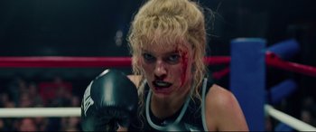 Movie still from “I, Tonya” (2017), directed by Craig Gillespie – A woman in a boxing ring with blood on her face; Close Up shot, Low angle