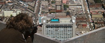 Movie still from “Dirty Harry” (1971), directed by Don Siegel – An aerial view of a city with buildings and a pool; Wide shot, Overhead angle