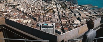 Movie still from “Dirty Harry” (1971), directed by Don Siegel – An aerial view of a large city with many buildings; Extreme Wide shot, High angle